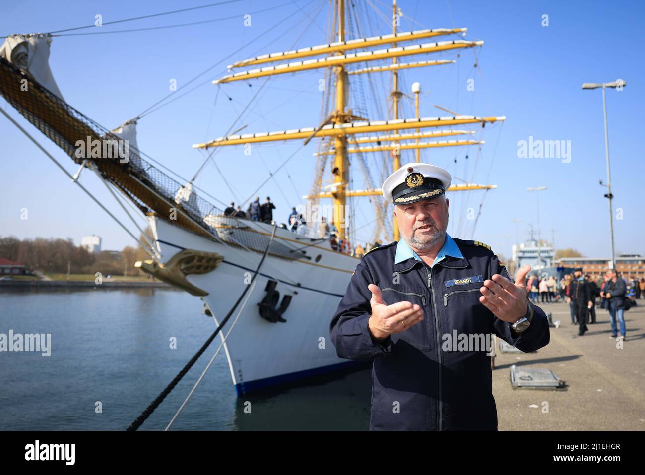 Kiel, Germany. 25th Mar, 2022. Nils Brandt, captain of the sail training ship 'Gorch Fock,' gives an interview after docking at the naval base in Kiel-Wik. The navy's sail training ship returned to its home port after a four-month training voyage. Credit: Christian Charisius/dpa/Alamy Live News Stock Photo