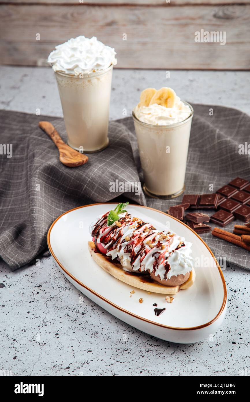 Banana split dessert with nuts with milkshakes Stock Photo Alamy
