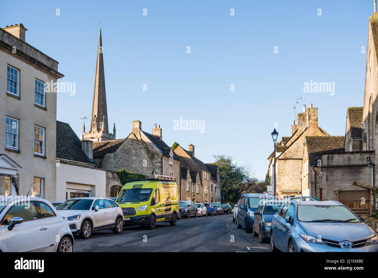 Too many cars parked along street outside of quintessential Cotswold stone cottages, Tetbury, Gloucestershire, UK Stock Photo