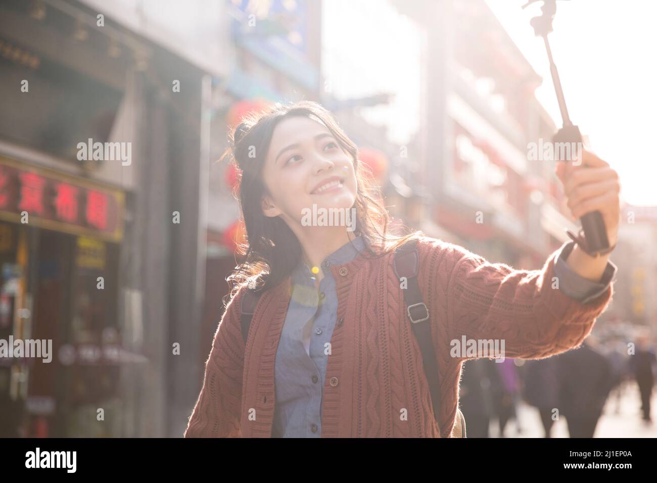 Female backpacker taking selfie at classic style pedestrian street - stock photo Stock Photo