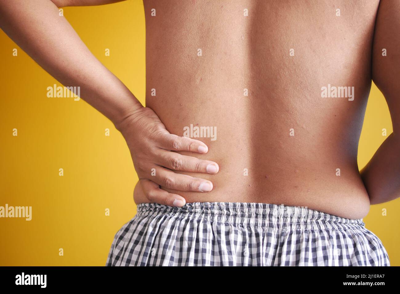young man suffering back pain close up Stock Photo - Alamy