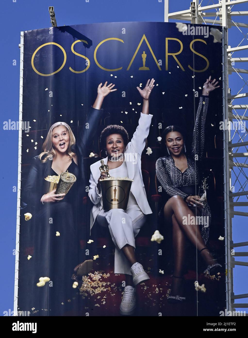 Los Angeles, United States. 25th Mar, 2022. An oversized replica of the official 94th annual Academy Awards ceremony of hosts Amy Schumer, Wanda Sykes and Regina Hall (L-R) hovers over Hollywood Blvd. as the Oscar ceremony is hours away at the Dolby Theatre in the Hollywood section of Los Angeles on March 24, 2022. Oscar winners will be announced during an ABC telecast on Sunday, March 27th. Photo by Jim Ruymen/UPI Credit: UPI/Alamy Live News Stock Photo