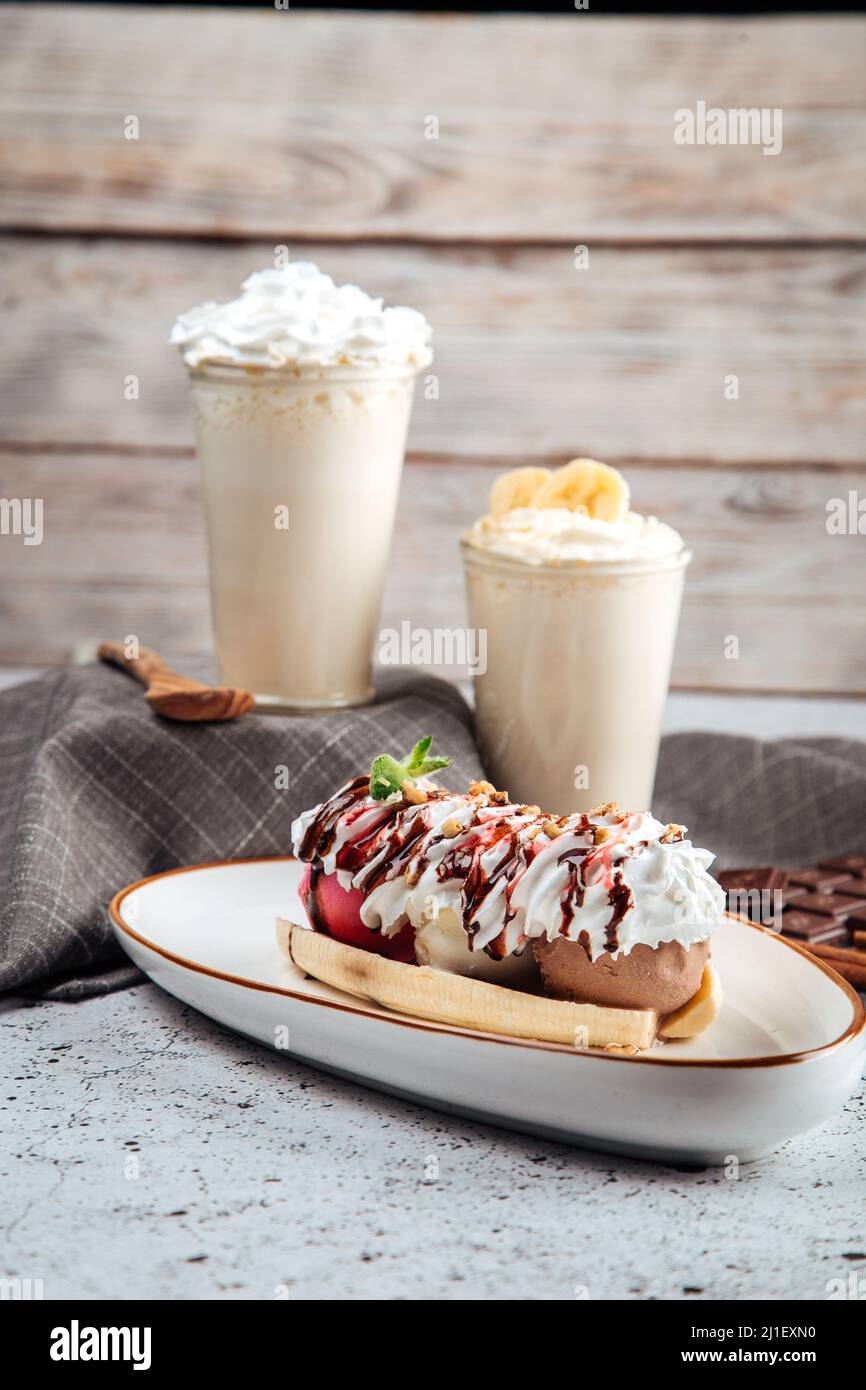 Banana split dessert with nuts with milkshakes Stock Photo Alamy