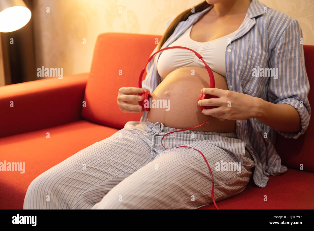 Pregnant woman with headphones on belly, Stock Photo, Picture And Royalty  Free Image. Pic. WR0252878