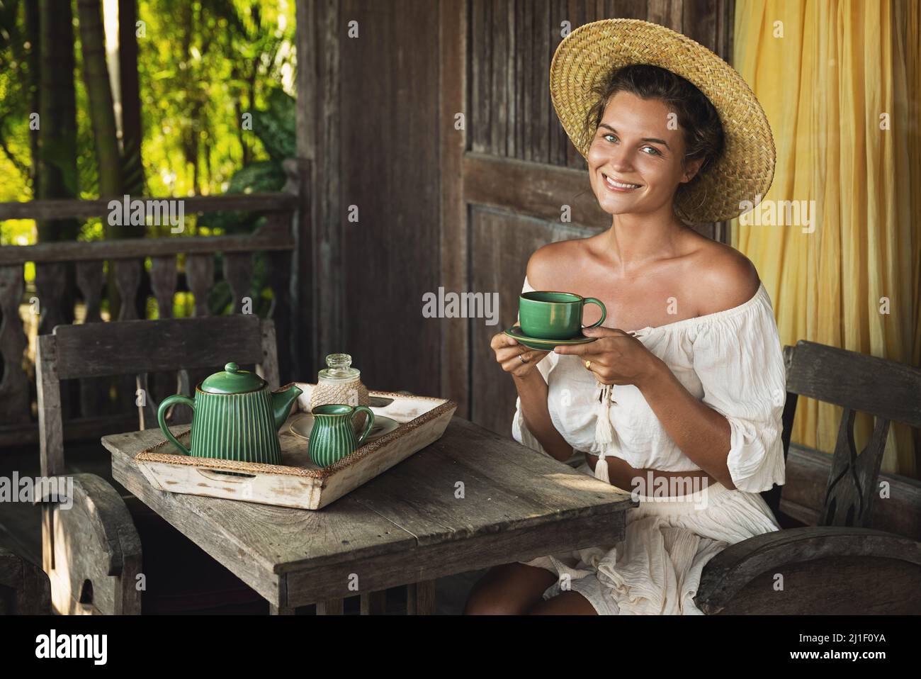Happy woman sitting on the summer terrace and drinking coffee Stock ...