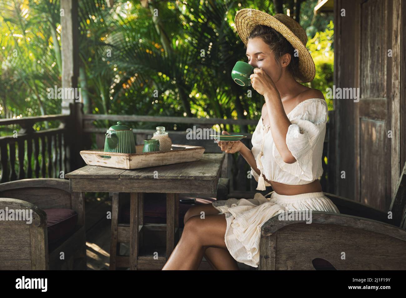 Happy woman sitting on the summer terrace and drinking coffee Stock ...