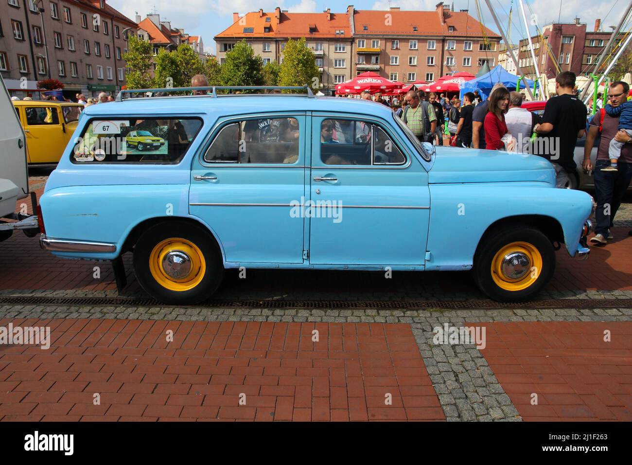 BYTOM, POLAND - SEPTEMBER 12, 2015: People walk by FSO Warszawa during 12th Historic Vehicle Rally in Bytom. The annual vehicle parade is one of main Stock Photo