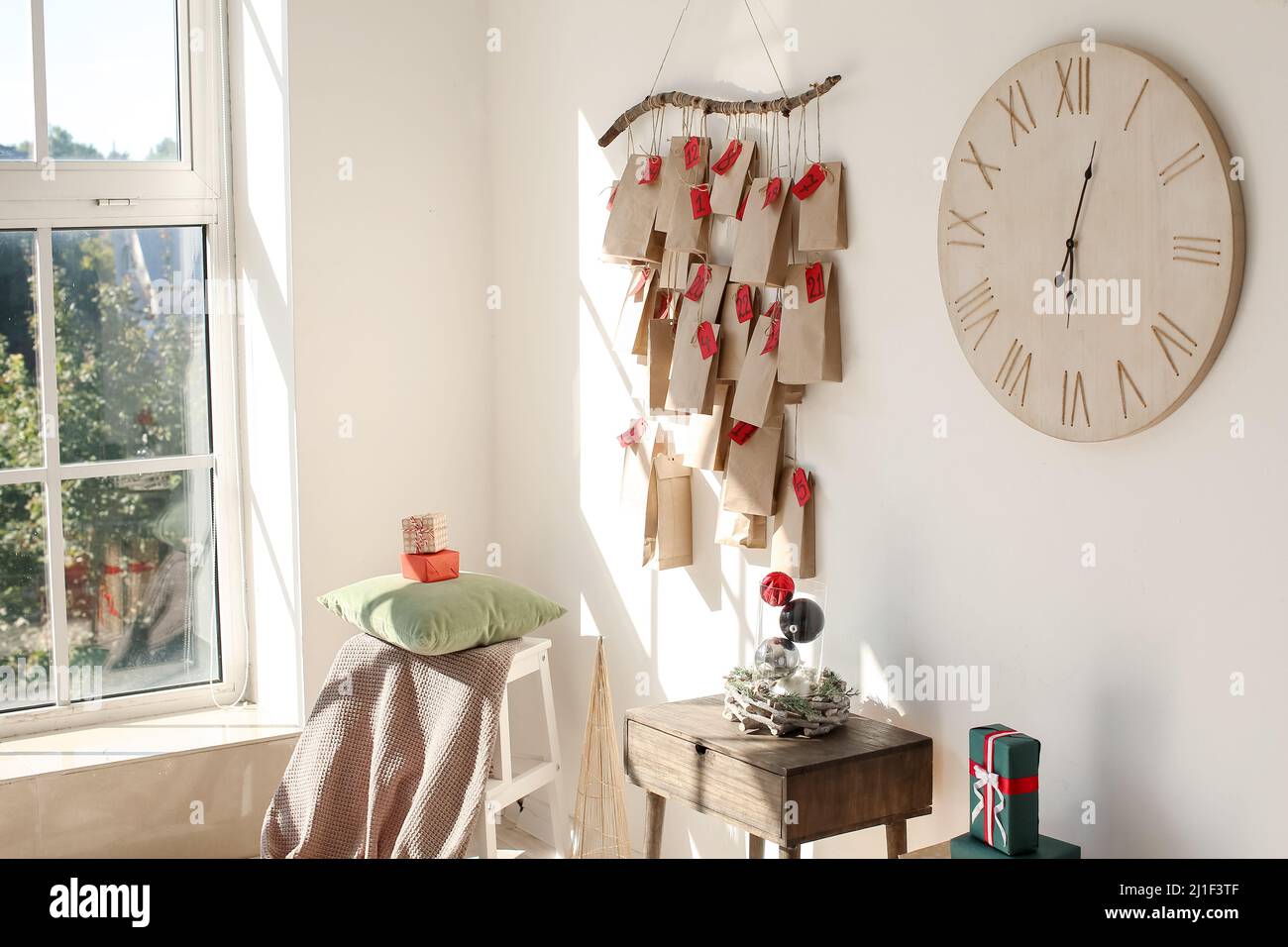Christmas decor, clock and stylish advent calendar hanging on white