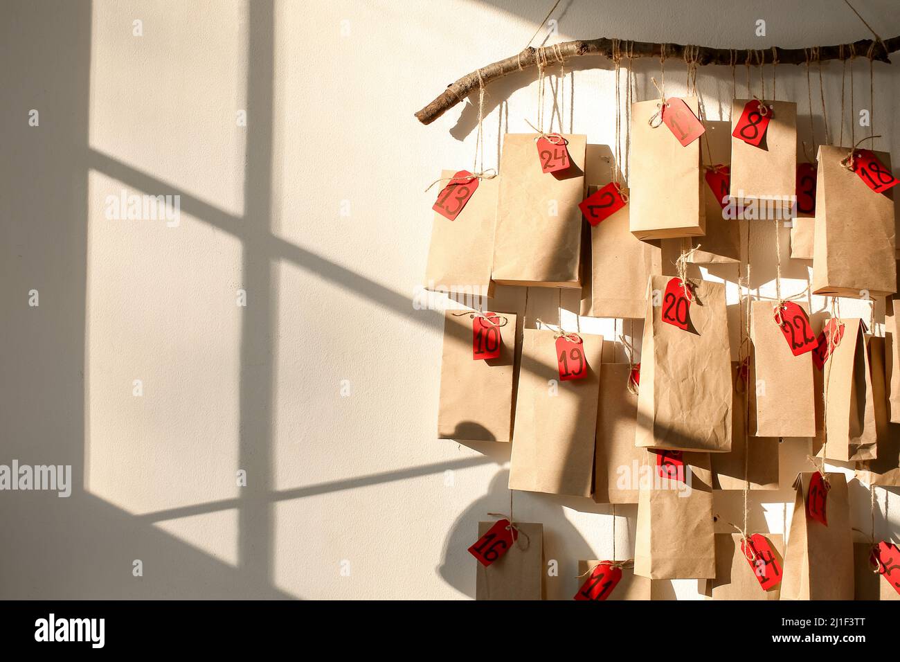 Stylish advent calendar hanging on white wall in room Stock Photo Alamy