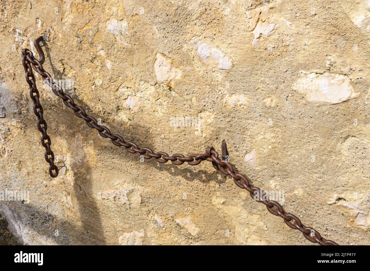 Heavy iron chain used as a banister or handrail on a medieval castle wall. Stock Photo