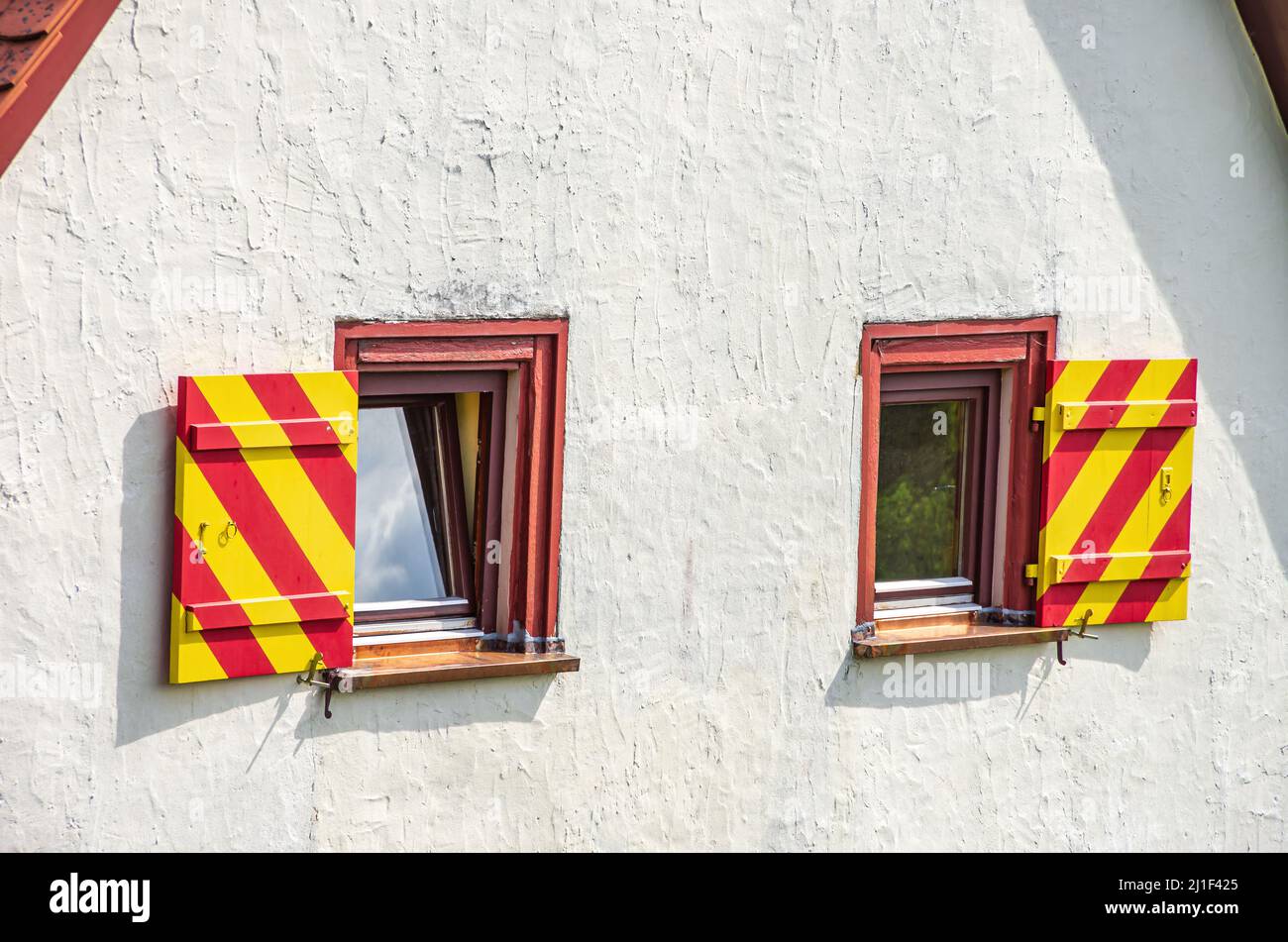 Window with colourfully painted shutters, gable end of a medieval castle building, Derneck Castle, Swabian Alb, Germany. Stock Photo