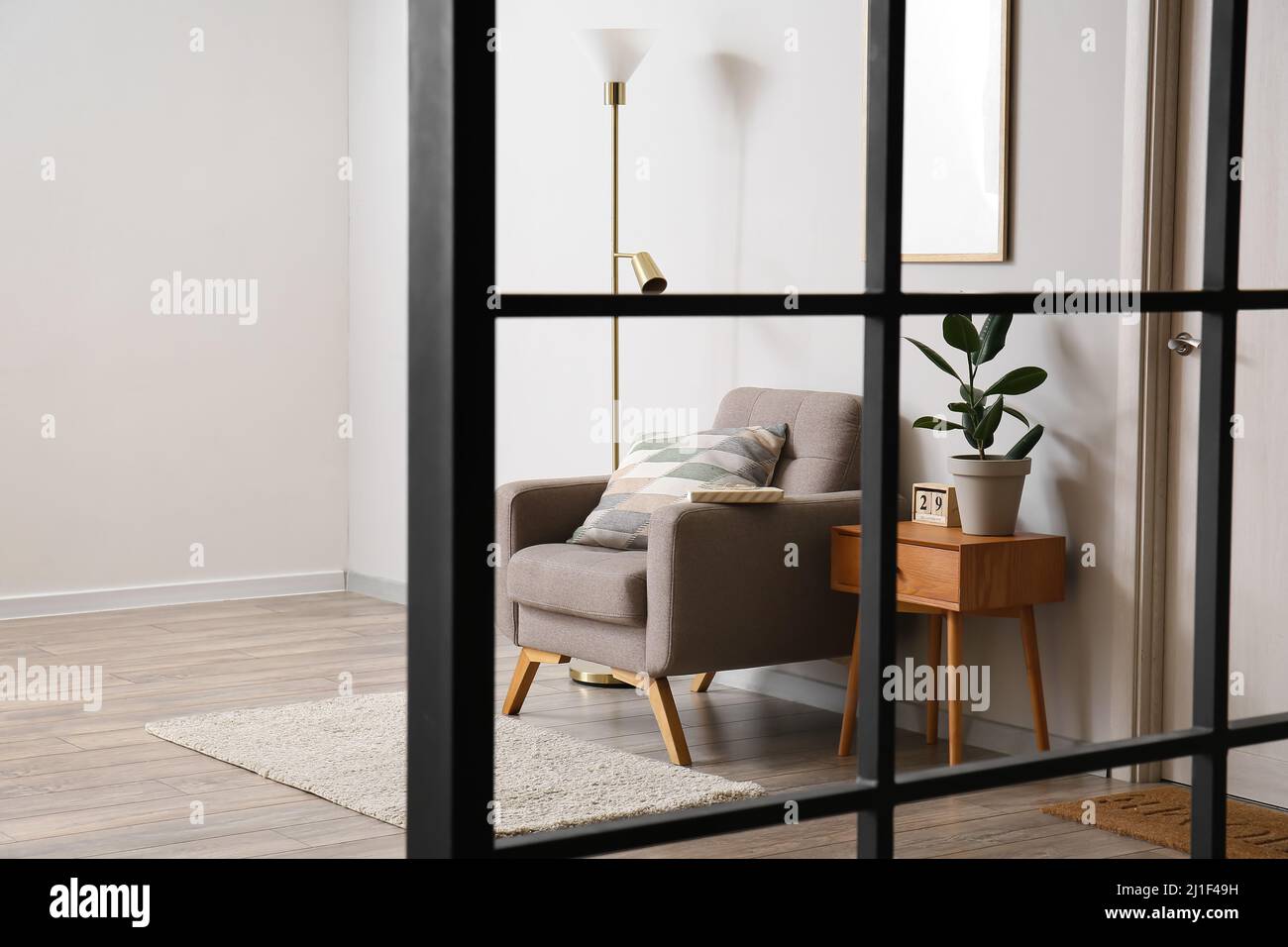 Interior of modern room with standing lamp, armchair and table Stock ...