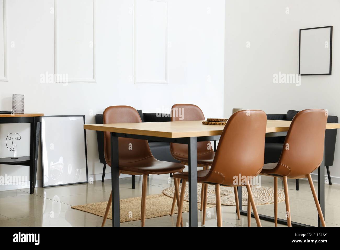 Interior of modern dining room with table and black armchairs Stock ...