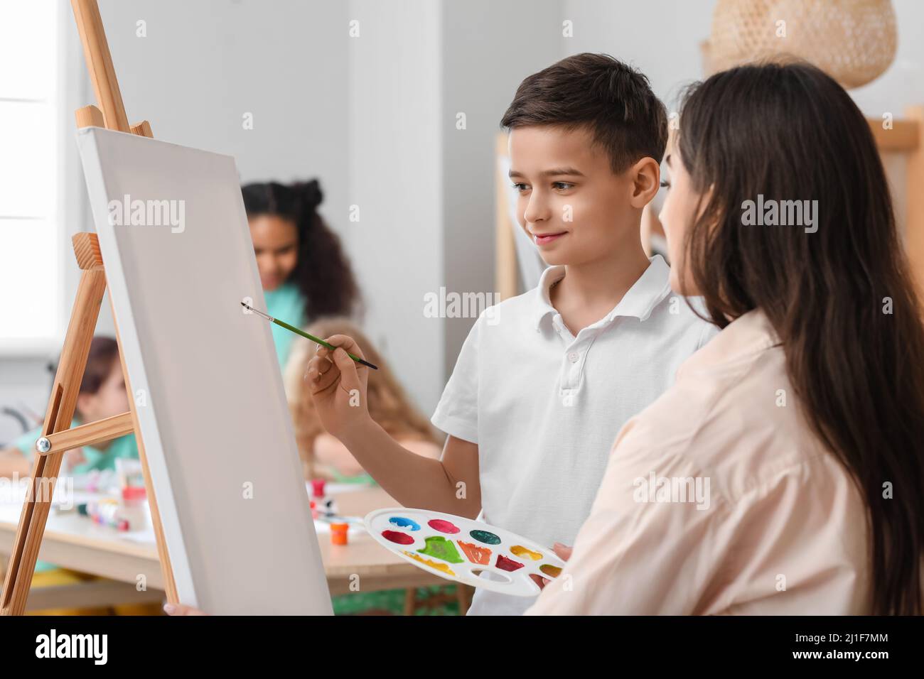 Cute boy and teacher during master-class in art Stock Photo