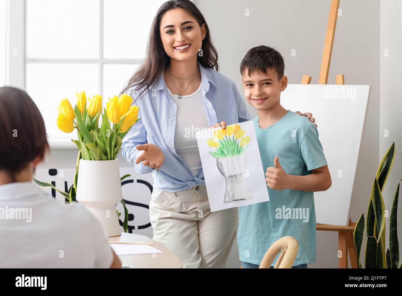 Cute boy and teacher during master-class in art Stock Photo
