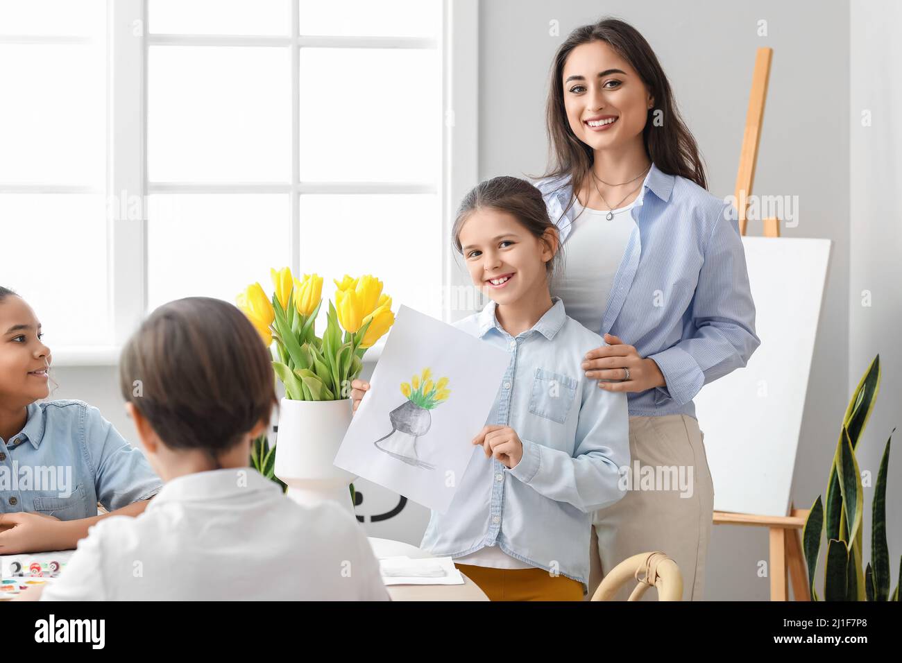 Cute girl and teacher during master-class in art Stock Photo