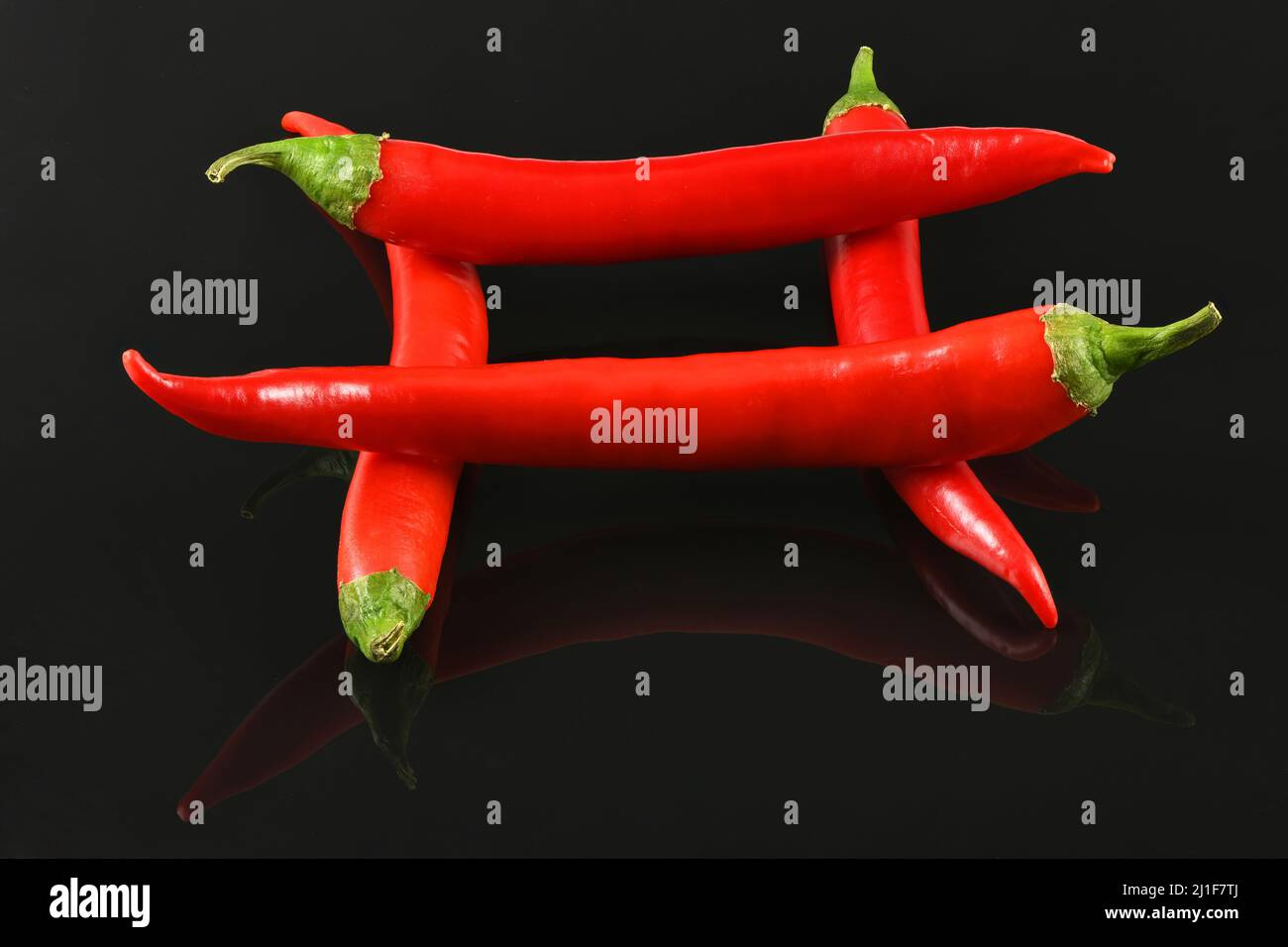 Red chili pepper isolated on black background. High resolution photo