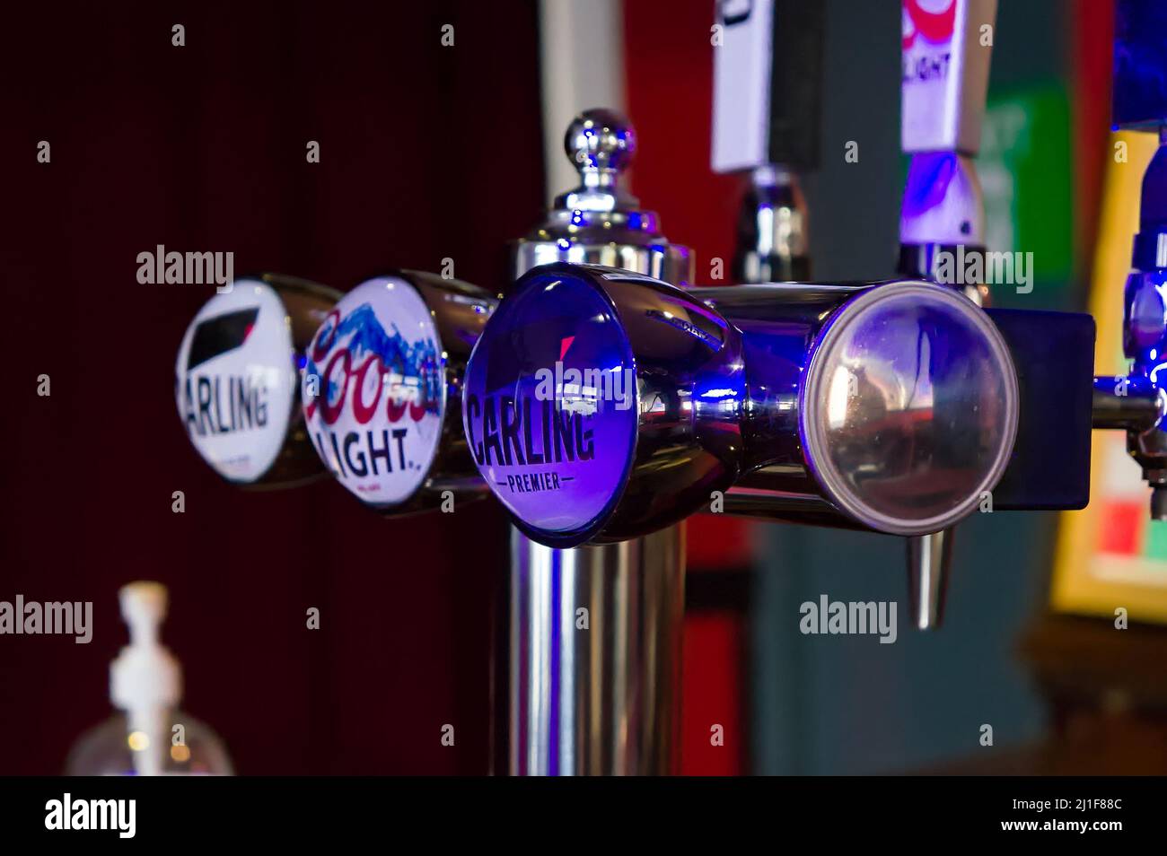 Beer brands displayed on the draught beer pumps in a UK pub with soft focus background Stock Photo