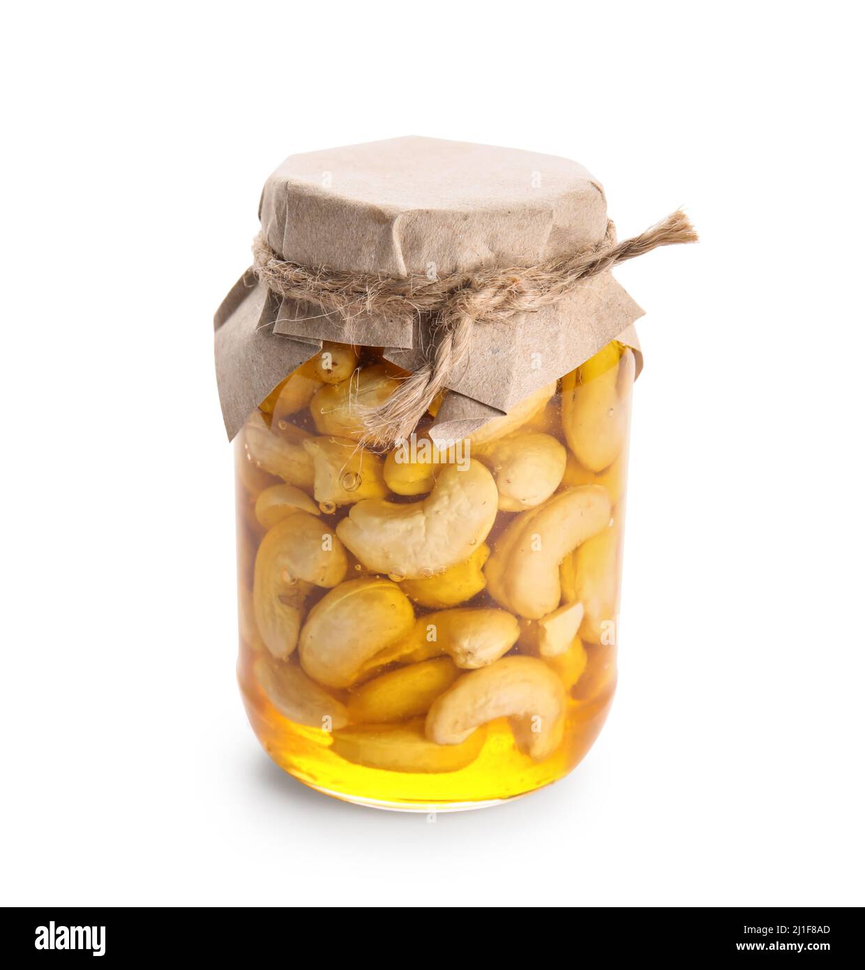 Jar of tasty cashew nuts with honey on white background Stock Photo - Alamy