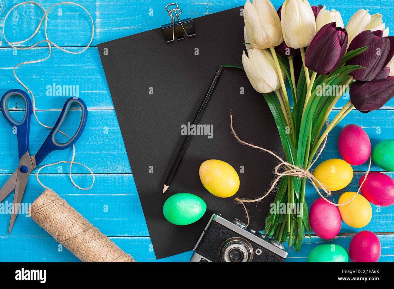 Easter eggs and tulips on blue rustic wooden planks Stock Photo - Alamy