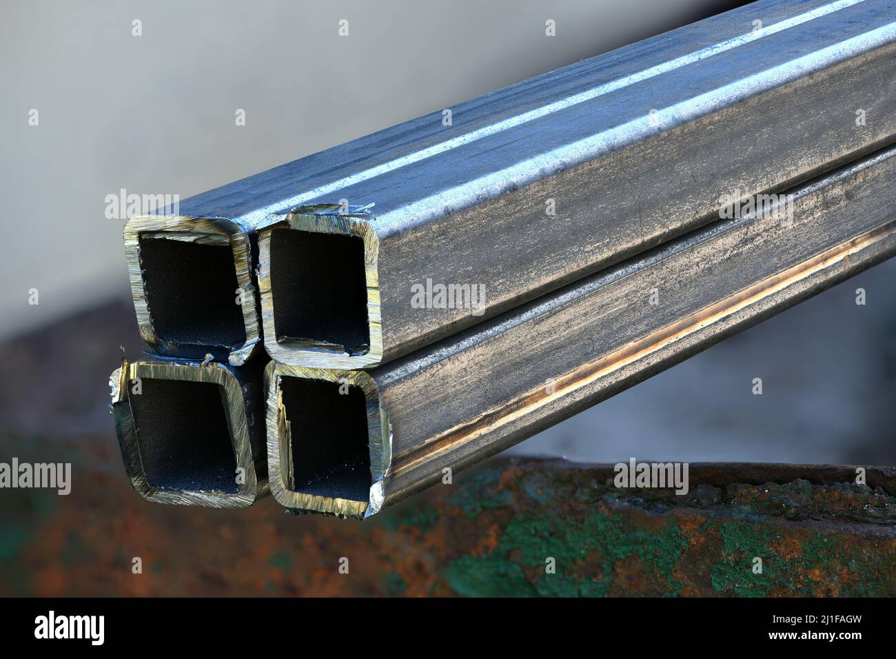 Metal profile pipe cutting. Cut metal pipe with a grinder. High