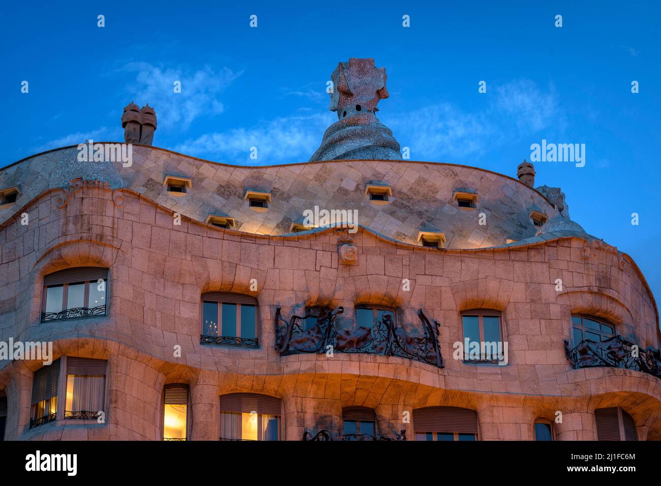 Casa Milà (La Pedrera) at sunset, twilight and blue hour on the Passeig de Gracia in Barcelona (Catalonia, Spain) ESP: La Casa Milà al atardecer (BCN) Stock Photo