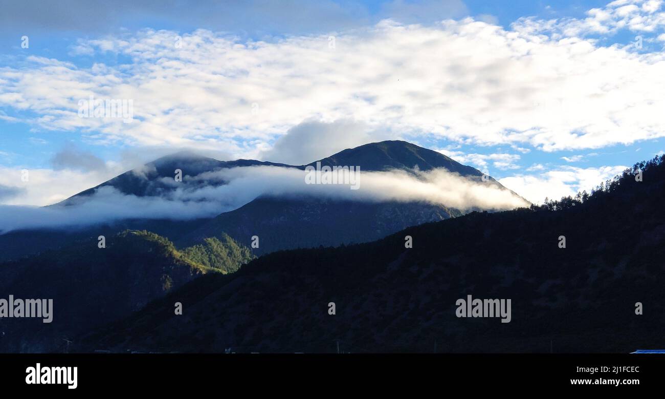 A panoramic view of beautiful clouds over the mountains Stock Photo - Alamy