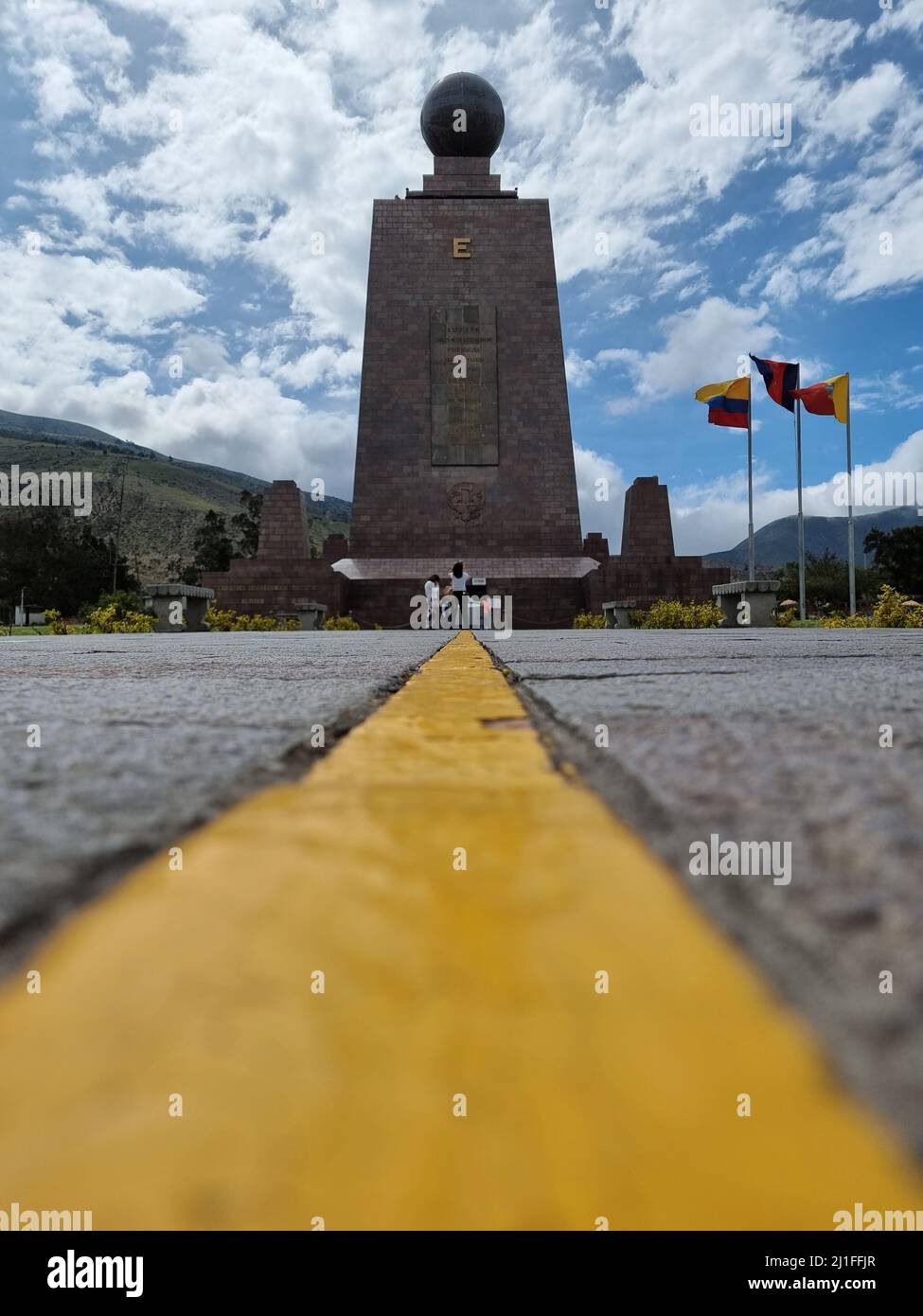 A vertical distant view of the Ciudad Mitad del Mundo monument in Quito