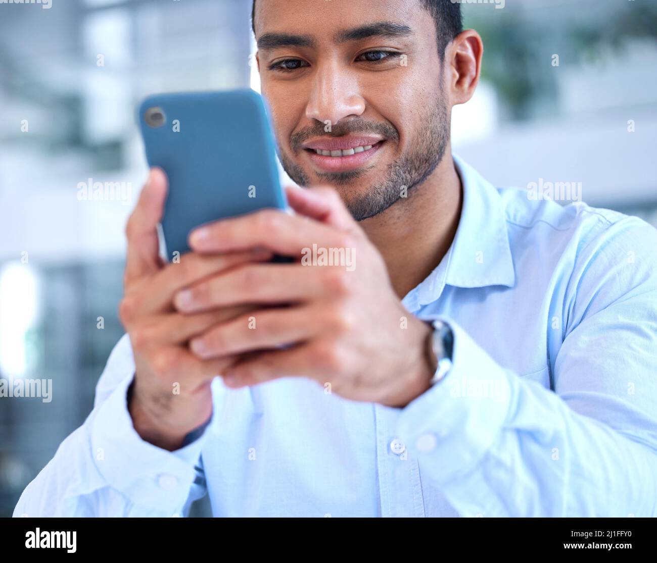 Lets see what theyre up to. Shot of a young businessman using his ...