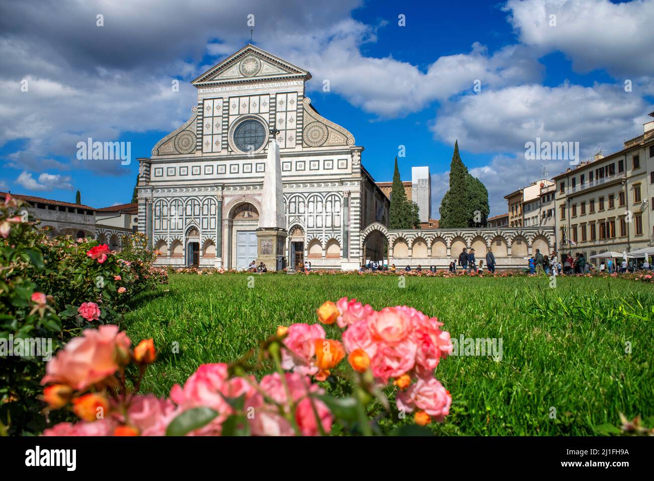 Facade of the Basilica of Santa Maria Novella on blue sky background and people in Florence city center old town Tuscany Italy Stock Photo