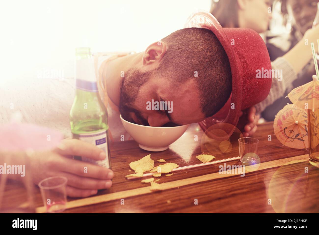 Get this man a bigger bowl. Real party of guys and girls getting drunk. Stock Photo