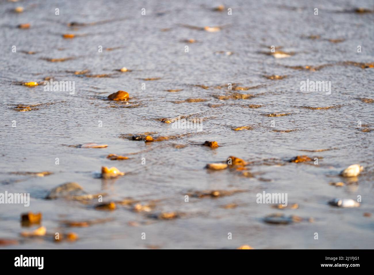 Water retreating with ripples in the sea Stock Photo - Alamy