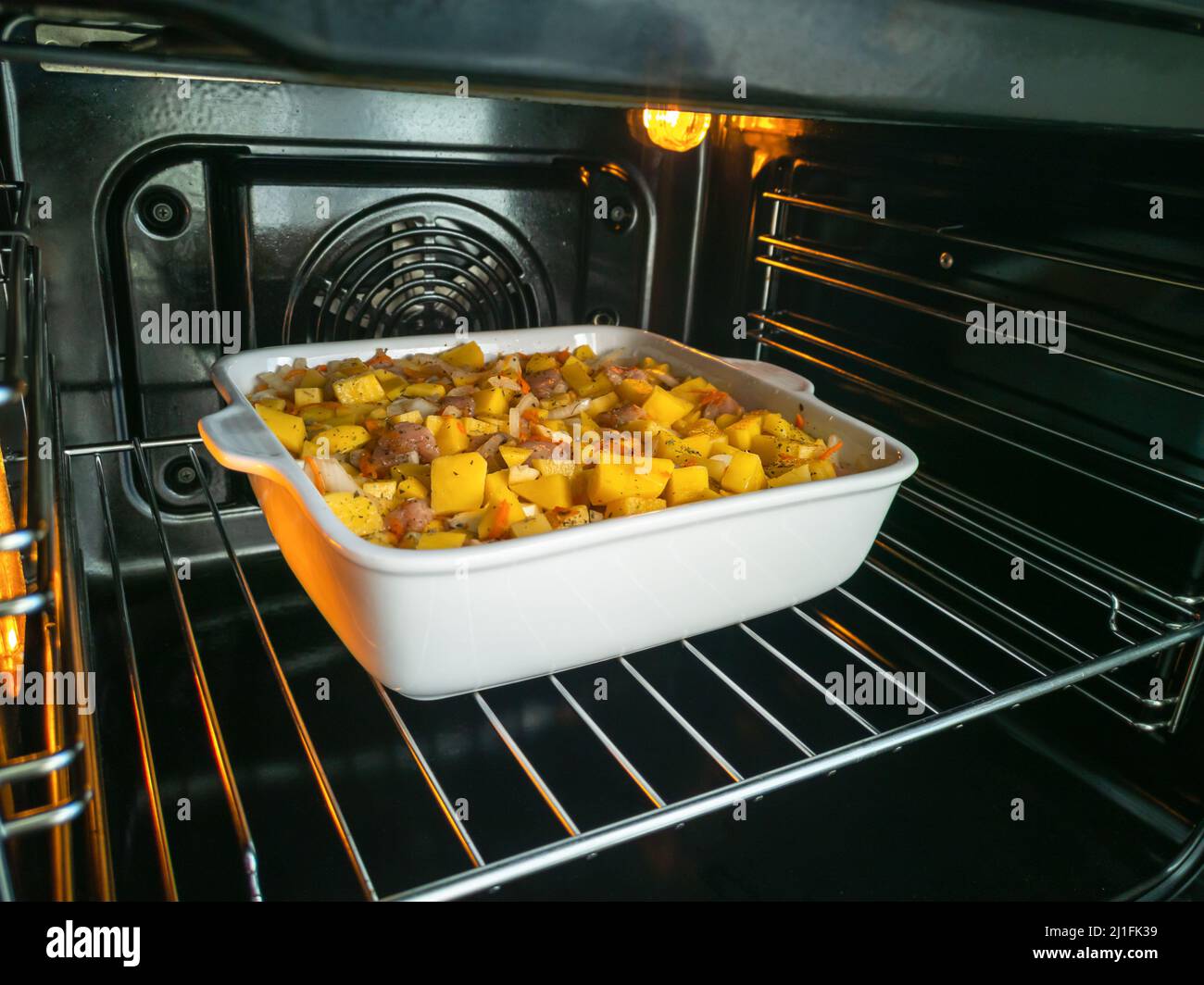 Cooking homemade food in an electric oven. Vegetable stew with potatoes