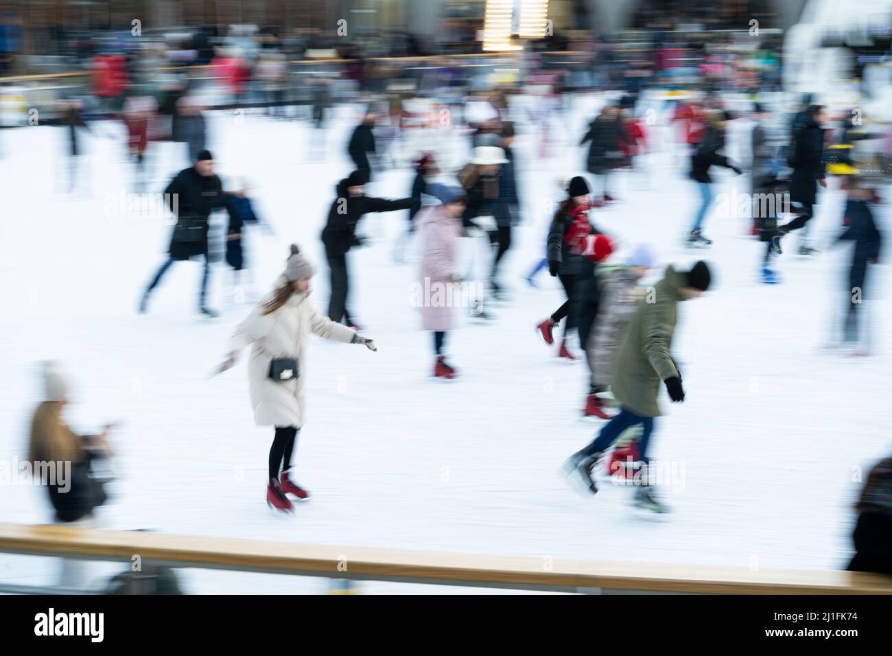 Ukraine, Kyiv - January 7, 2022: Ice skating rink in winter. People are ...