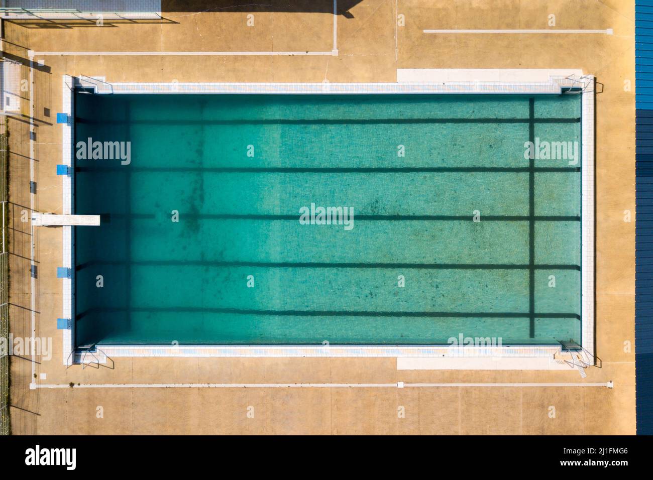 Aerial view of a dirty swimming pool few weeks before the opening season. Stock Photo
