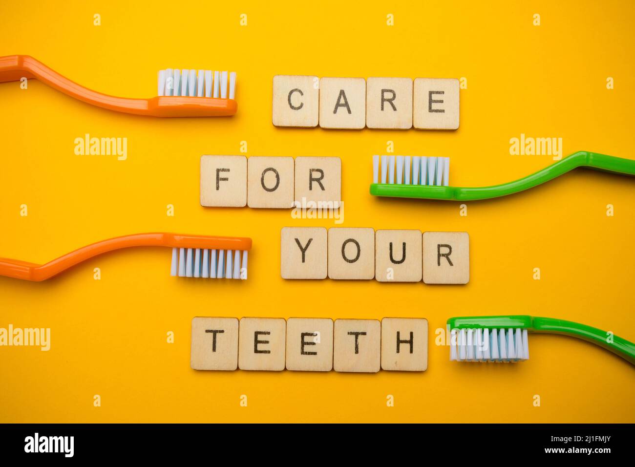 Oral and dental health concept showing four toothbrushes and a sign