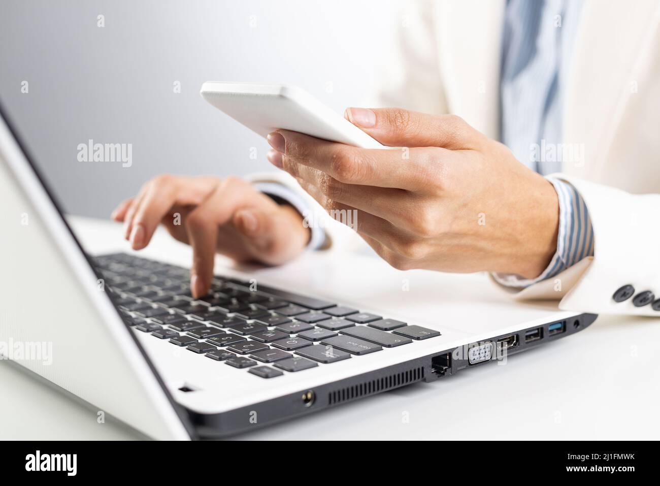 Man in business suit holding smartphone Stock Photo - Alamy