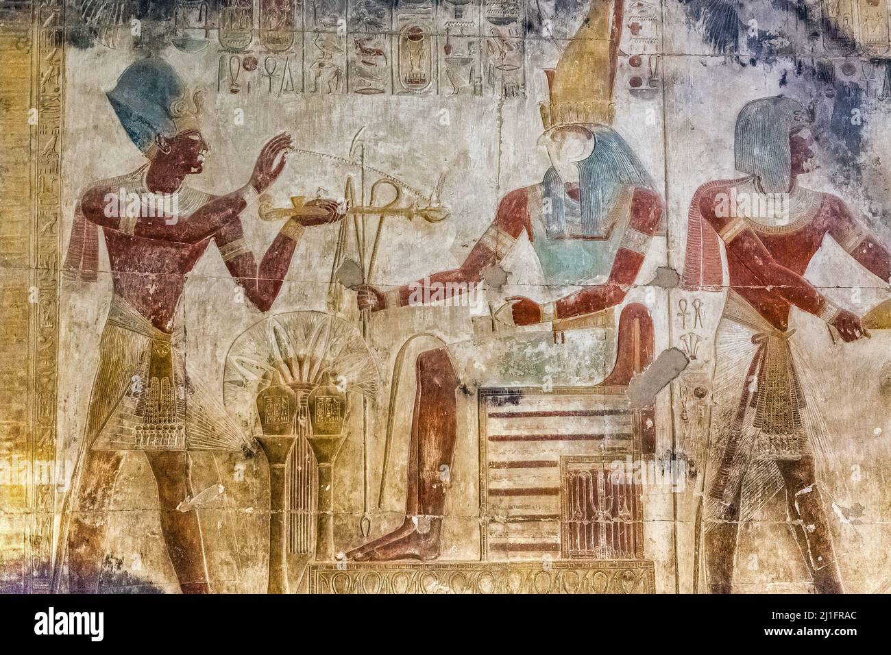 King Seti I offering incense to the god Horus, who is seated on a