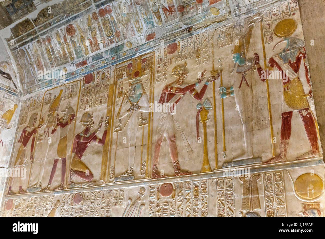 Ancient Egyptian chapel in the Great Temple of Abydos, featuring King Seti I with the deities Thoth, Osiris and Wepwawet Stock Photo