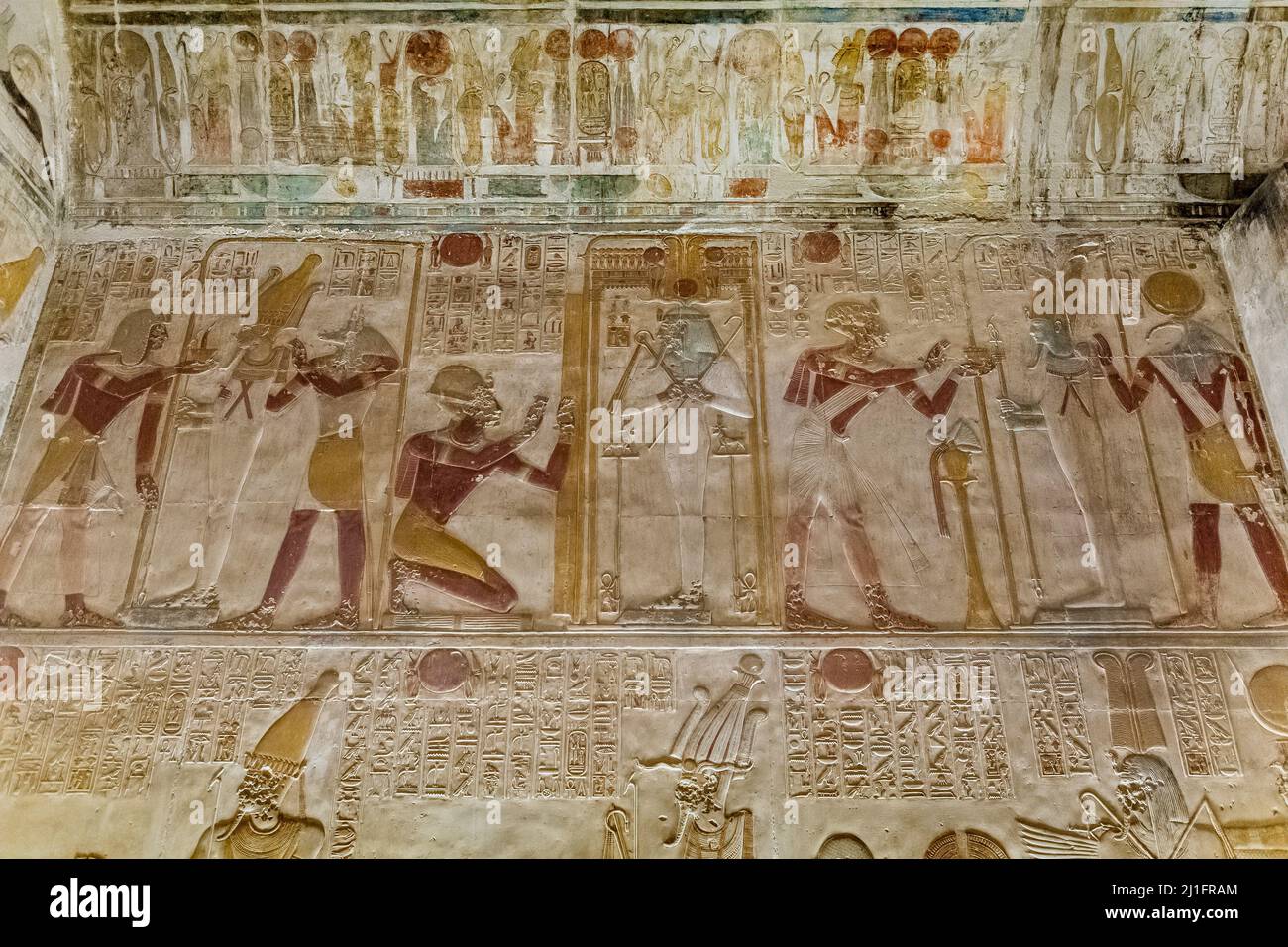 Ancient Egyptian chapel in the Great Temple of Abydos, featuring King Seti I with the deities Thoth, Osiris and Wepwawet Stock Photo