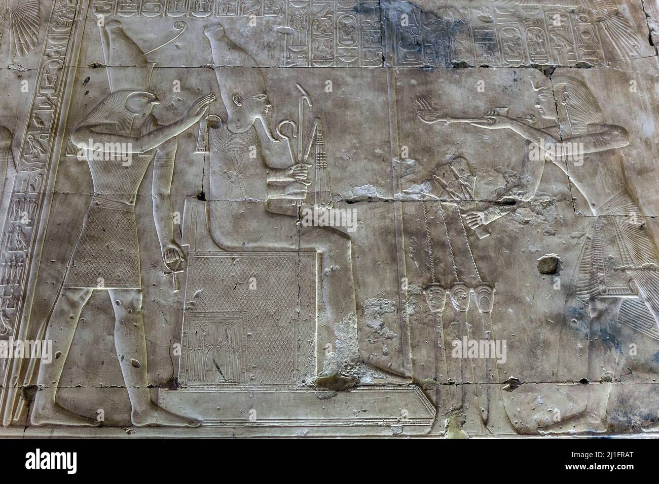 Stone carving of King Seti I offering incense to the deities Osiris and Horus in the Great Temple of Abydos, Egypt Stock Photo