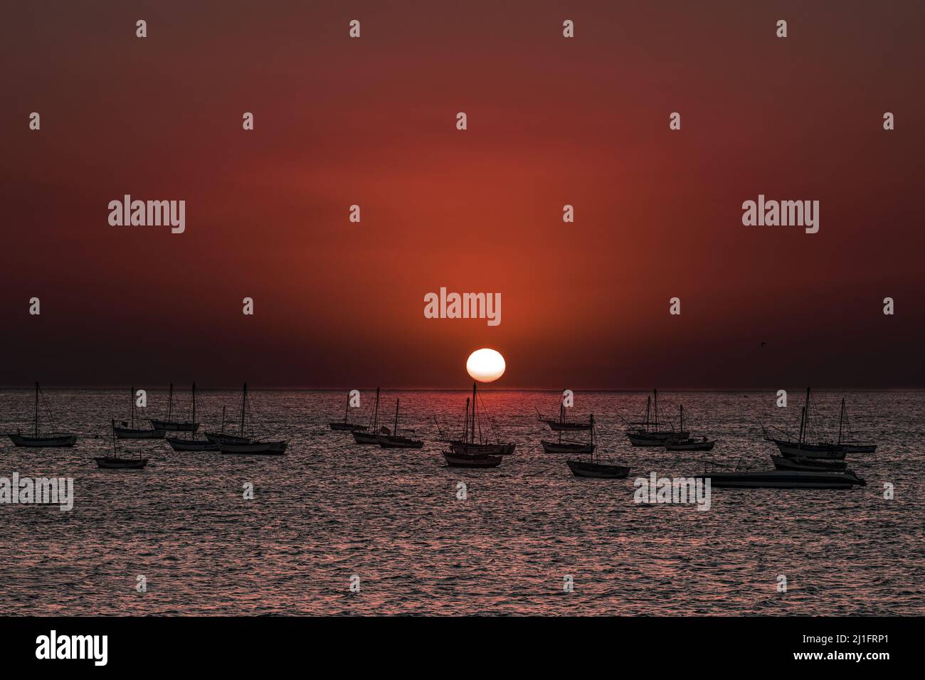 A beautiful shot of a sunset sky over a sea with many boats Stock Photo ...
