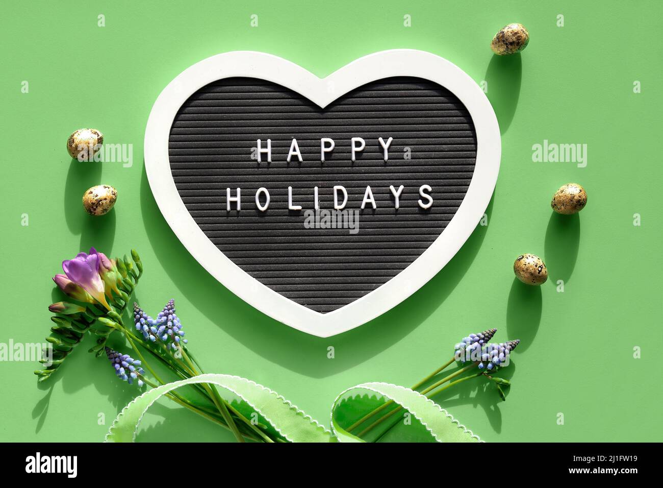 Happy Holidays text on felt heart shaped letter board, letterboard