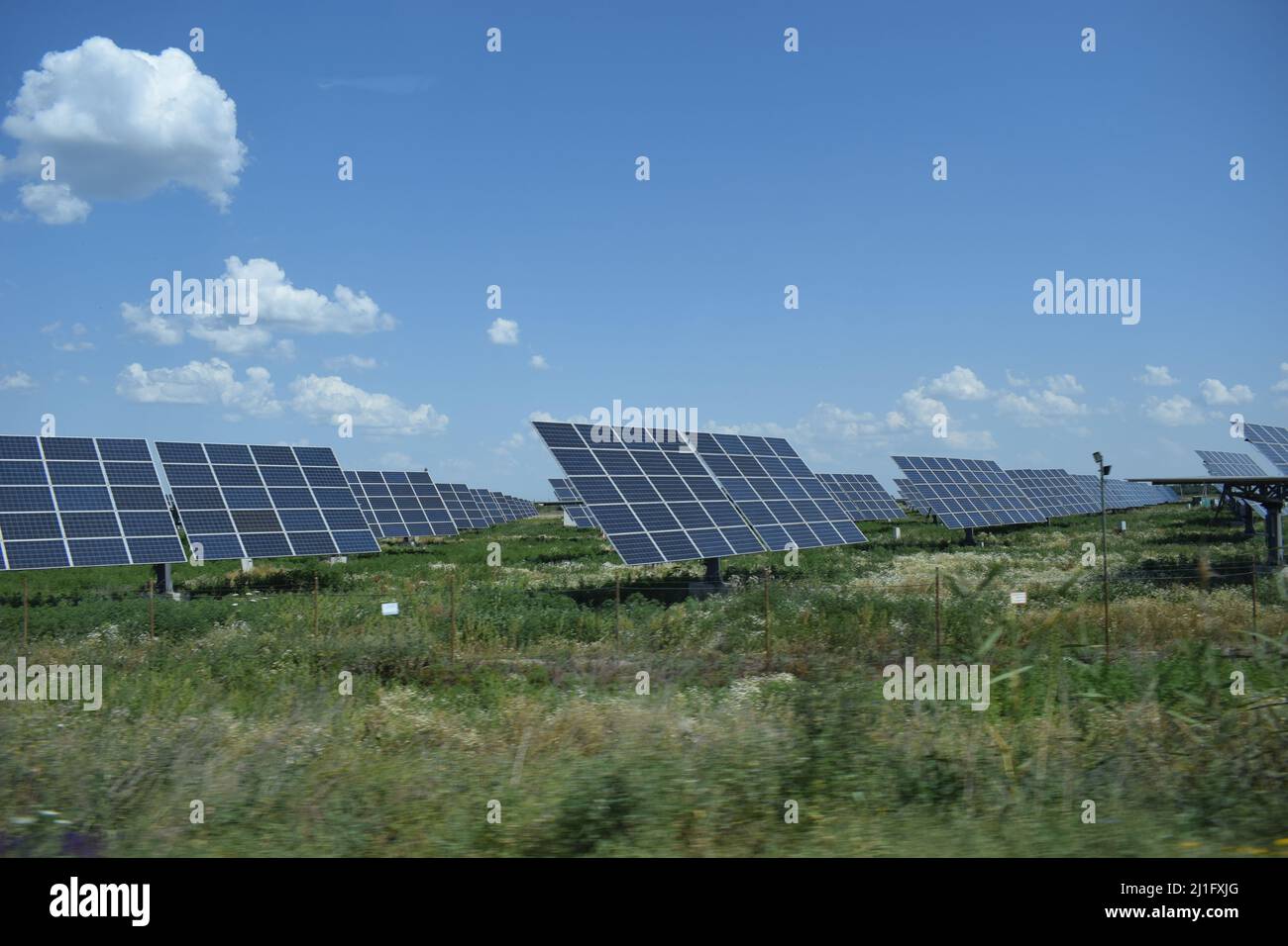 Solar power station in arid area under clear blue sky. Solar power equipment. Solar panel, photovoltaic, alternative electricity source. Stock Photo