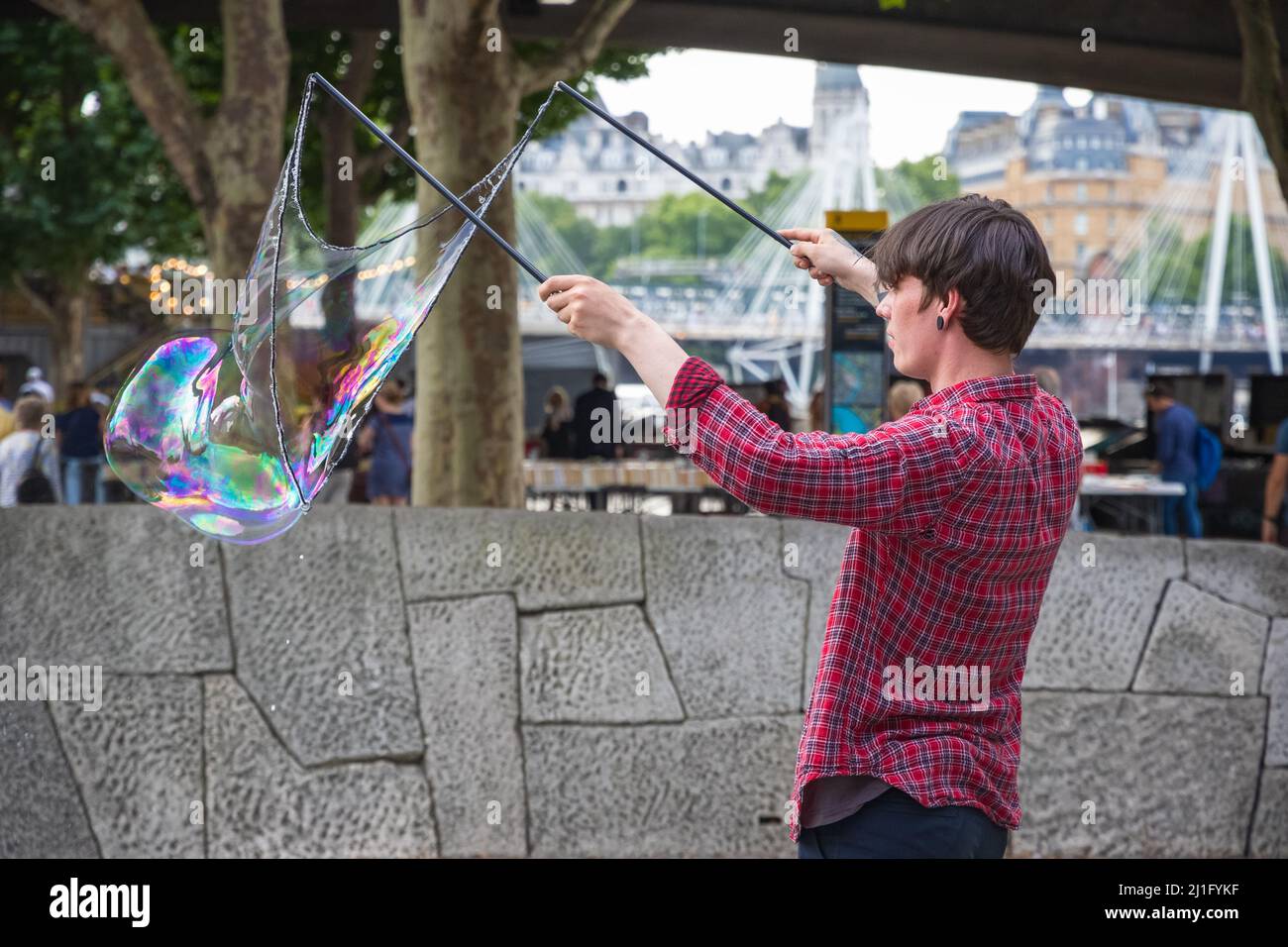 London, UK - July 19, 2021 - A soap bubble street performer at the South Bank district in central London Stock Photo