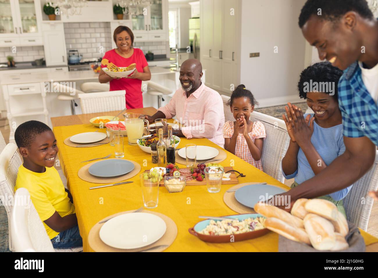 Happy african american multi-generational family having lunch at home on thanksgiving day Stock Photo