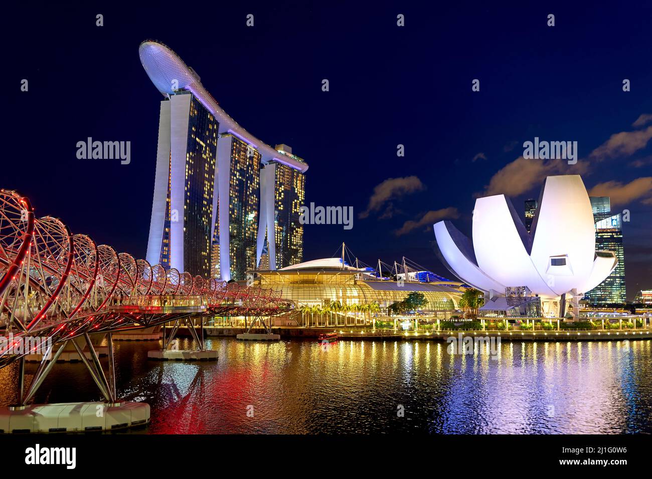 Singapore. Marina Bay Sands Hotel at sunset. Helix bridge. ArtScience Museum Stock Photo