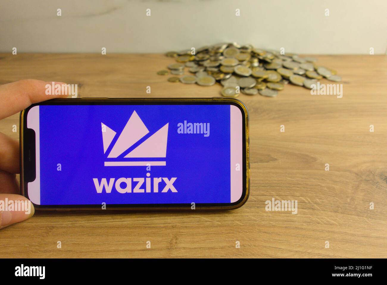 KONSKIE, POLAND - March 20, 2022: WazirX cryptocurrency exchange logo on mobile phone. Online trading, blockchain technology concept Stock Photo