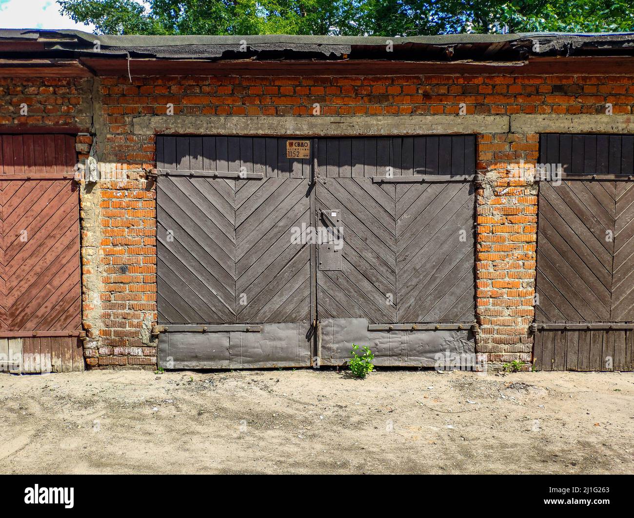 Grey wooden door to an old garage. Stock Photo