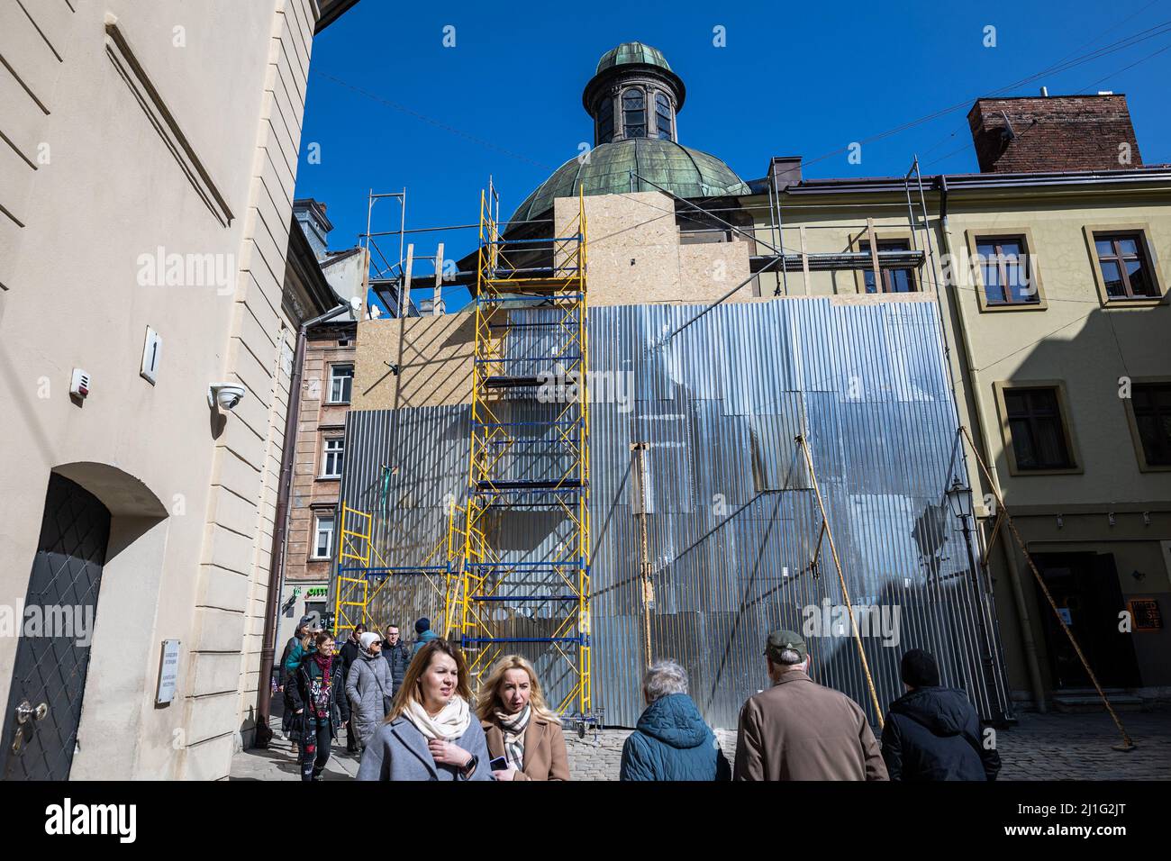 LVIV, UKRAINE - March 20, 2022: Protective structures base on scaffolding for protection facade of The Boim Chapel in case of bombing are nailed with Stock Photo
